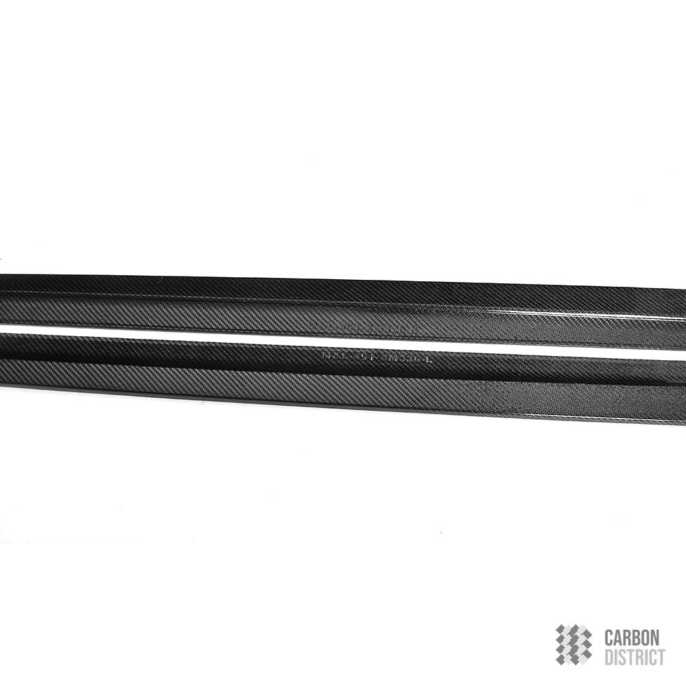 BMW M5 (F90) carbon fibre side skirts — 3K twill gloss finish