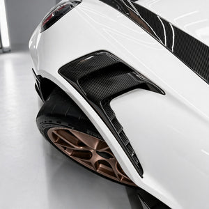 Dry carbon fender vent and front knife wing on a white Porsche 911 GT3 RS (992)