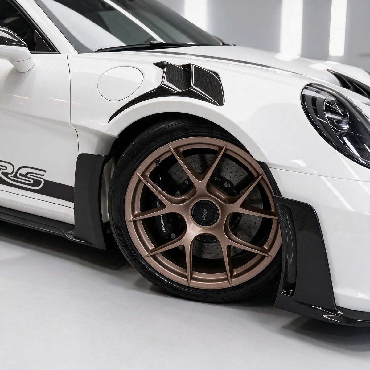 Dry carbon bonnet vent inserts, front knife wings and bronze wheel on a Porsche 911 GT3 RS (992)