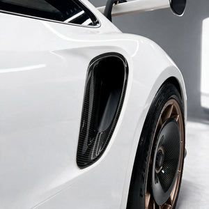 Dry carbon rear quarter air duct and rear wheel carbon aero disc on a Porsche 911 GT3 RS (992)