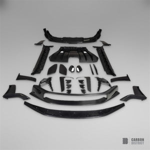 Porsche 911 GT3 RS (992) dry carbon fibre body kit — every part in the kit laid out in the Carbon District studio