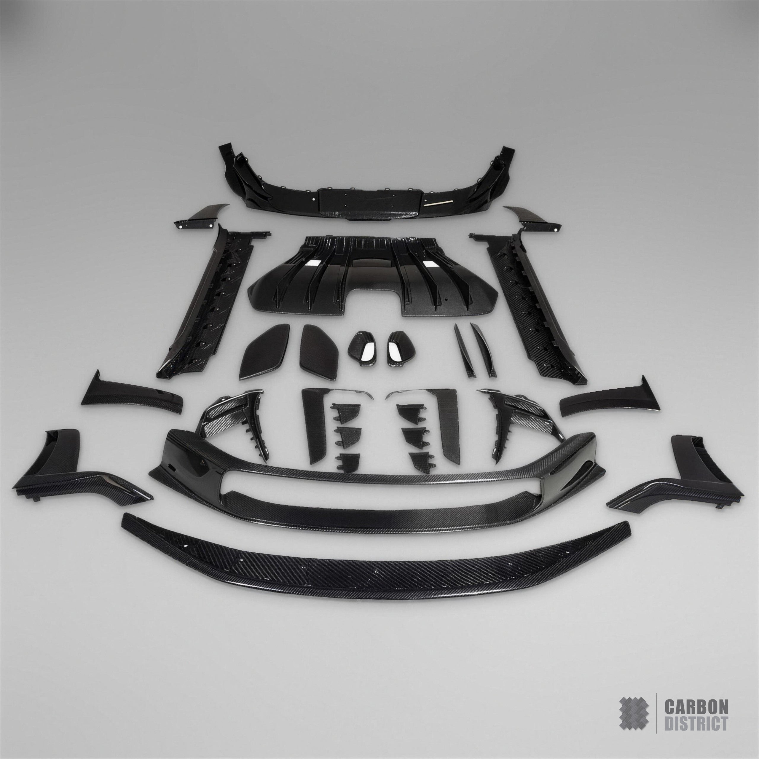 Porsche 911 GT3 RS (992) dry carbon fibre body kit — every part in the kit laid out in the Carbon District studio