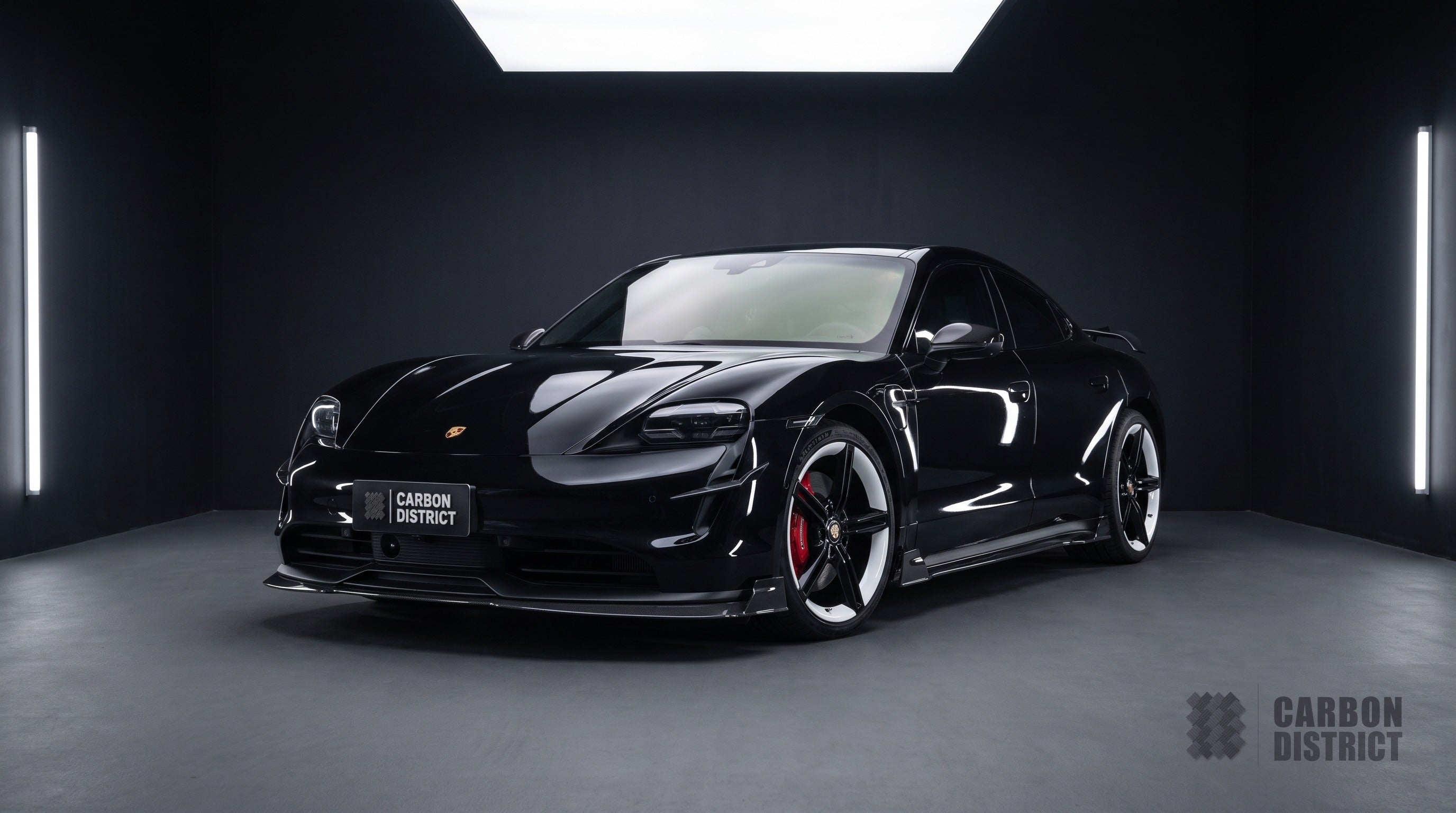 Porsche Taycan carbon fibre body kit with raised wing, front three-quarter
