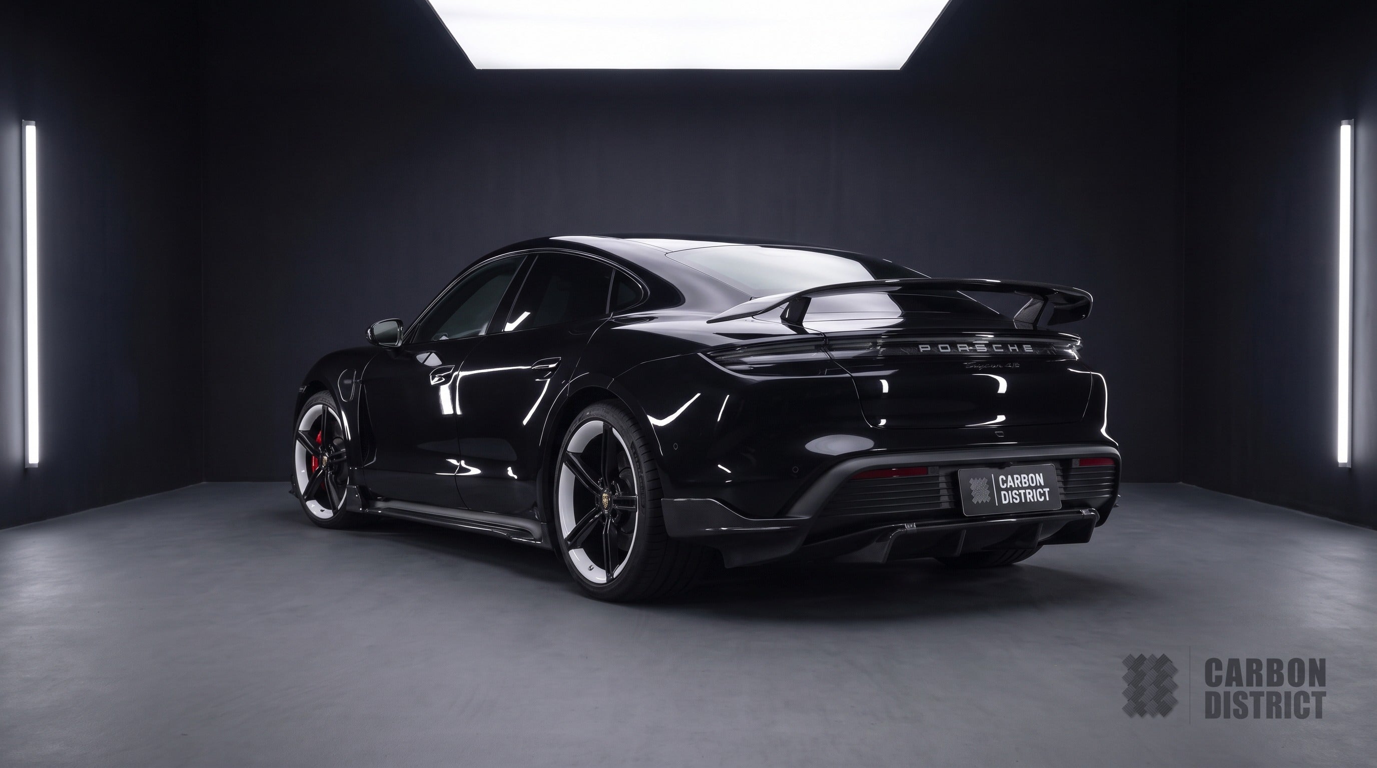 Porsche Taycan carbon fibre body kit with raised wing, rear three-quarter